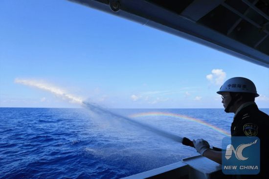 File photo taken on April 4, 2016 shows a crew member takes part in a fire drill on China's largest and most advanced patrol vessel Haixun 01 on the South China Sea. (Xinhua/Xing Guangli)   