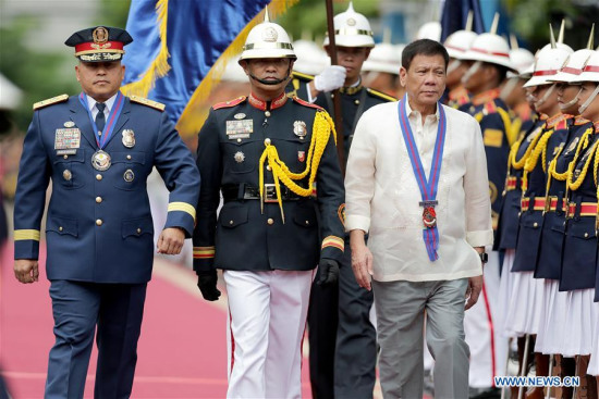 Philippine President Rodrigo Duterte (3rd L), accompanied by Philippine National Police Chief Ronald dela Rosa (1st L), during Ronald dela Rosa's assumption of command ceremony in Quezon City July 1, 2016. (Xinhua/Rouelle Umali)