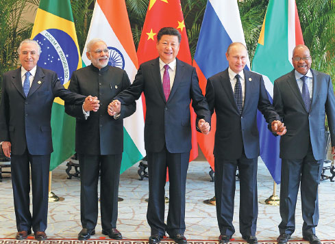 President Xi Jinping (center) takes a group photo with Indian Prime Minister Narendra Modi (2nd left), Brazilian President Michel Temer (left), Russian President Vladimir Putin (2nd right) and South African President Jacob Zuma (right) ahead of the G20 Summit in Hangzhou, Zhejiang, on Sunday. (Photo by Xu Jingxing / China Daily)