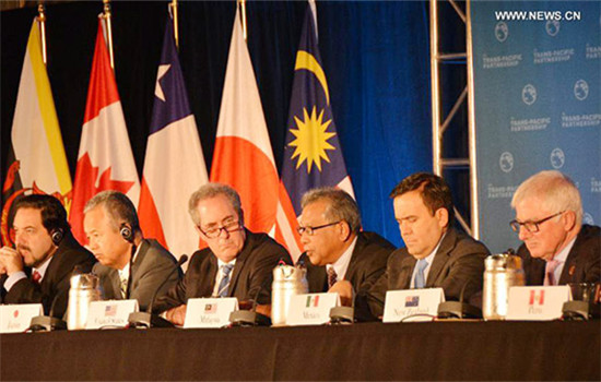 Trade ministers of the United States and 11 other Pacific Rim countries attend a press conference after negotiating the Trans-Pacific Partnership (TPP) trade agreement in Atlanta, the United States, on Oct. 5, 2015. (Photo/Xinhua)