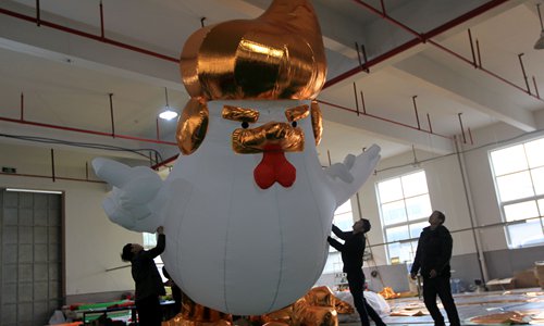 Workers show to visitors an inflatable chicken that local media say bears resemblance to U.S. President-elect Donald Trump as their factory braces for the Year of the Rooster in Jiaxing, Zhejiang province, China January 12, 2017. (Photo: GT/Yang Hui)