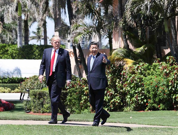 Chinese President Xi Jinping (R) and his US counterpart Donald Trump (L) take a walk to further discuss bilateral cooperation issues in the Mar-a-Lago resort in Florida, the United States, April 7, 2017. (Photo/Xinhua)