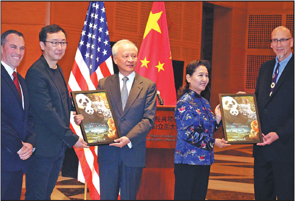 Cui Tiankai, ambassador to the U.S. (center), Walt Disney Studios Vice-President Paul Baribault (left) and Chinese documentary director Lu Chuan (second from the left) display a poster for Born in China, a Chinese-American coproduction that takes viewers on an epic journey into the wilds of the country. The film was released in the United States over the weekend. Zhao Huanxin / China Daily
