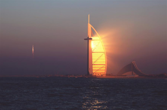 The hotel Burj Al-Arab is seen during sunset in Dubai, the United Arab Emirates (UAE), Dec. 30, 2016. The UAE, located at the intersection of the Belt and Road Initiative, is an important partner for China to promote the Belt and Road Initiative. (Xinhua/Li Zhen)