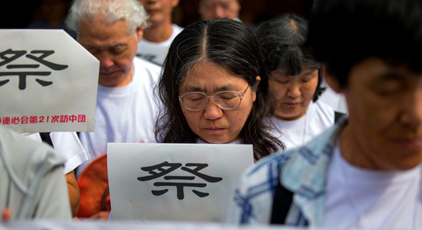 Members of a Japanese delegation mourn outside the Memorial Hall of the Victims in Nanjing Massacre by Japanese Invaders in Nanjing on Tuesday. YANG BO/CHINA NEWS SERVICE