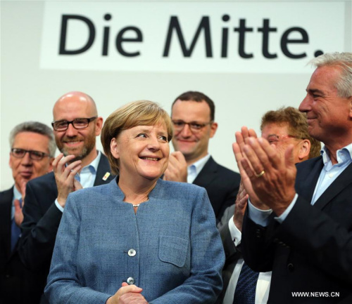 German sitting Chancellor Angela Merkel (L, Front) is applauded after the preliminary exit poll at the Christian Democratic Union (CDU) party's headquarters in Berlin, Germany, on Sept. 24, 2017.  (Xinhua/Luo Huanhuan)
