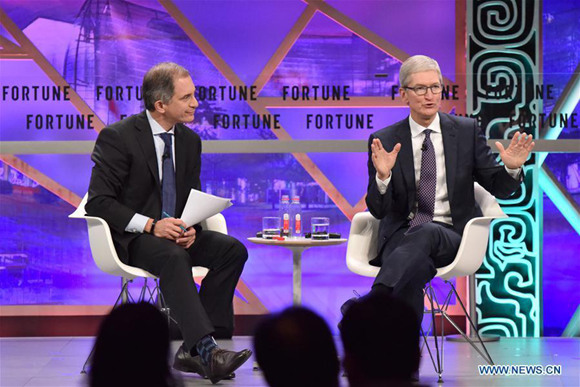 Tim Cook (R), chief executive officer of Apple, speaks at a plenary session during the 2017 Fortune Global Forum in Guangzhou, south China's Guangdong Province, Dec. 6, 2017. (Xinhua/Sun Ruibo)
