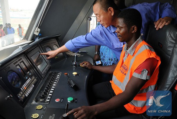 Chinese technician Wei Rujun trains Nigerian train driver. (Photo/Xinhua)