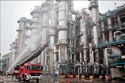 A fire engine is seen putting out a blaze yesterday at a petrochemical factory that burned for hours. More than 50 engines were dispatched.