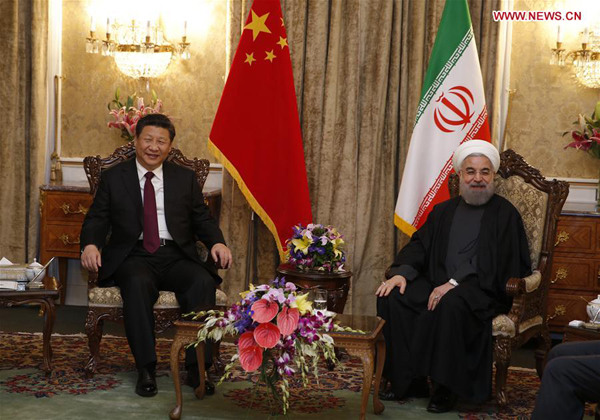 Chinese President Xi Jinping (L) talks with Iranian President Hassan Rouhani in Tehran, Iran, Jan. 23, 2016. (Xinhua/Ju Peng)