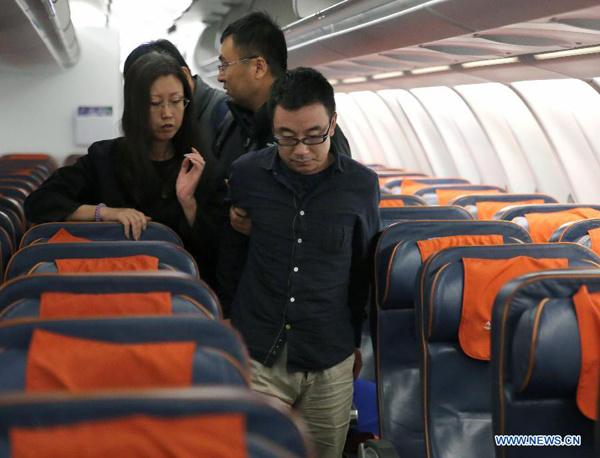 Fu Yaobo (R front) and Zhang Qingzhao (L front), two of China's most wanted fugitives,are taken back under escort at Beijing capital airport in Beijing,capital of China, Feb. 6, 2016. (Xinhua/Yin Gang)