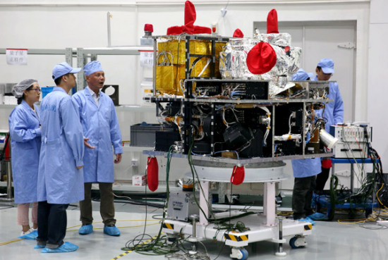 Scientists work on China's first quantum science satellite at a research center of the Chinese Academy of Sciences in Shanghai in May last year. (Photo/Xinhua)