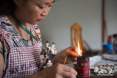 A worker makes ink brushes in Shanlian Huzhou Ink Brush Factory in Shanlian of Huzhou City, east China's Zhejiang Province, Aug. 7, 2017. The Hu Brush, one of the prestigious writing brush types in traditional Chinese writing and painting art, is the main product of the 50 year old factory that produces an annual amount of 600,000 brushes, reporting an annual output of 8 million yuan from both domestic market and other Asian countries. (Xinhua/Weng Xinyang)