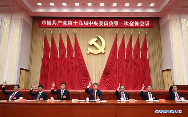 Xi Jinping (C), Li Keqiang (3rd R), Li Zhanshu (3rd L), Wang Yang (2nd R), Wang Huning (2nd L), Zhao Leji (1st R) and Han Zheng (1st L) attend the first plenary session of the 19th Communist Party of China (CPC) Central Committee at the Great Hall of the People in Beijing, capital of China, Oct. 25, 2017. (Xinhua/Ju Peng)
