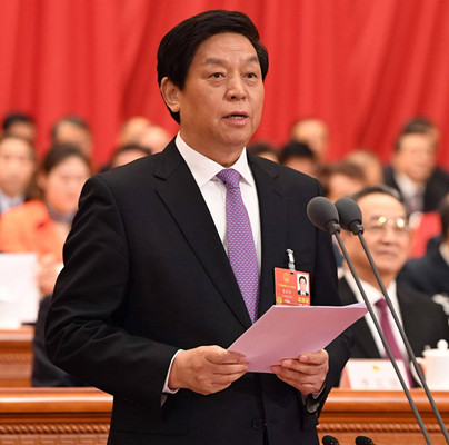 Li Zhanshu, chairman of the 13th National People's Congress Standing Committee, addresses the closing meeting of the first session of the 13th NPC on Tuesday.(Photo by Rao Aimin/Xinhua)