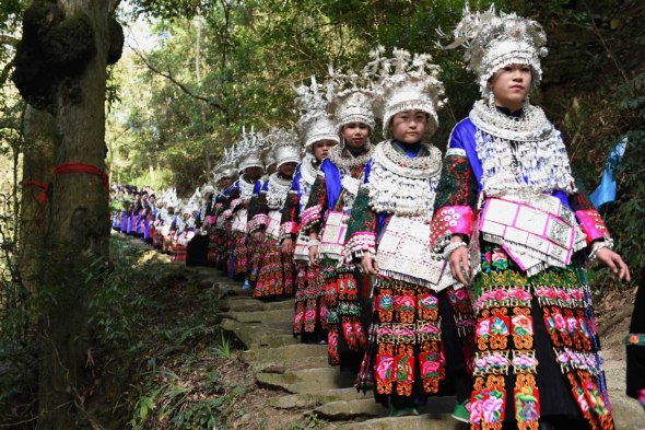 Women parade through a cedar forest in Denglu village in Taijiang county, Guizhou province during last year's Spring Festival. (Photo: Xinhua/Liu Kaifu)