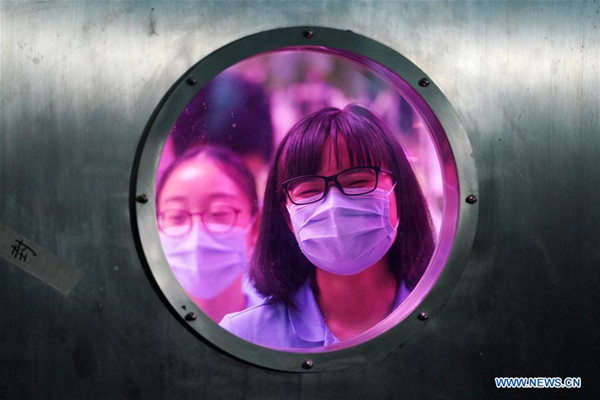 Volunteers prepare to leave the Yuegong-1, or Lunar Palace 1, at Beihang University in Beijing, capital of China, May 15, 2018. Chinese volunteers have completed a one-year test living in a simulated space lab in Beijing, setting a new record for the longest stay in a self-contained cabin. (Xinhua/Ju Huanzong)