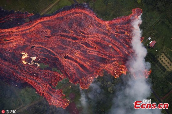 In this May 19, 2018 photo released by the U.S. Geological Survey, lava flows from fissures near Pahoa, Hawaii. Kilauea volcano began erupting more than two weeks ago and has burned dozens of homes, forced people to flee and shot up plumes of steam from its summit that led officials to distribute face masks to protect against ash particles. (Photo/IC)