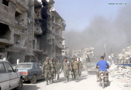 yrian soldiers walk in the Hajar al-Aswad district, south of Damascus, Syria, on May 21, 2018, just hours after it was declared free of the Islamic State (IS) militants. For the first time in seven years, Syria's capital Damascus was declared secure and empty of any rebel presence on Monday, following the defeat of the Islamic State (IS) in their last strongholds south of the capital, an achievement that closed the last chapter of war in the Syrian capital. (Xinhua/Hummam Sheikh Ali)