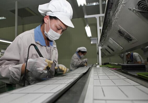 The production line of a solarpanelmaking company in Lianyungang, Jiangsu province. Chinese solarpanel makers said on Thursday that the EU's violation accusations are baseless and smack of trade friction. Si Wei / For China Daily