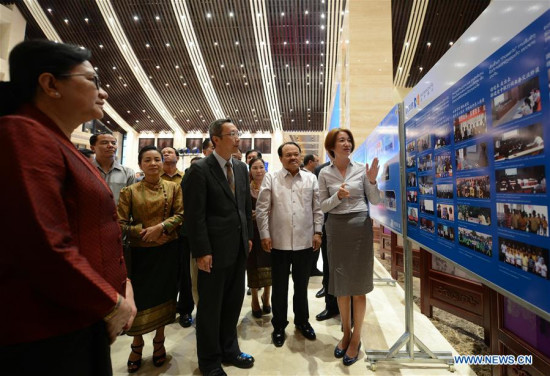 Delegates visit a photo exhibition of China-Laos cooperation in Vientiane, Laos, July 6, 2017. (Xinhua/Liu Ailun)