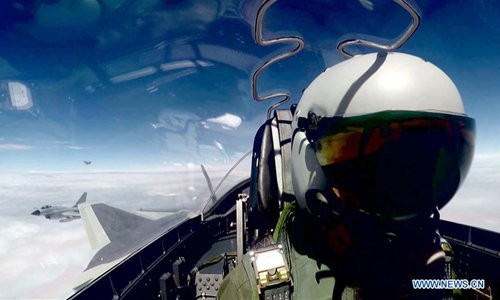 Undated file photo shows China's J-20 stealth fighter jets taking part in their first-ever combat training over the ocean. China's J-20 stealth fighter jets have begun their first-ever combat training over the ocean, a spokesperson confirmed Wednesday. The J-20 is China's fourth-generation medium and long-range fighter aircraft and was commissioned into air force combat service earlier this year. (Xinhua)