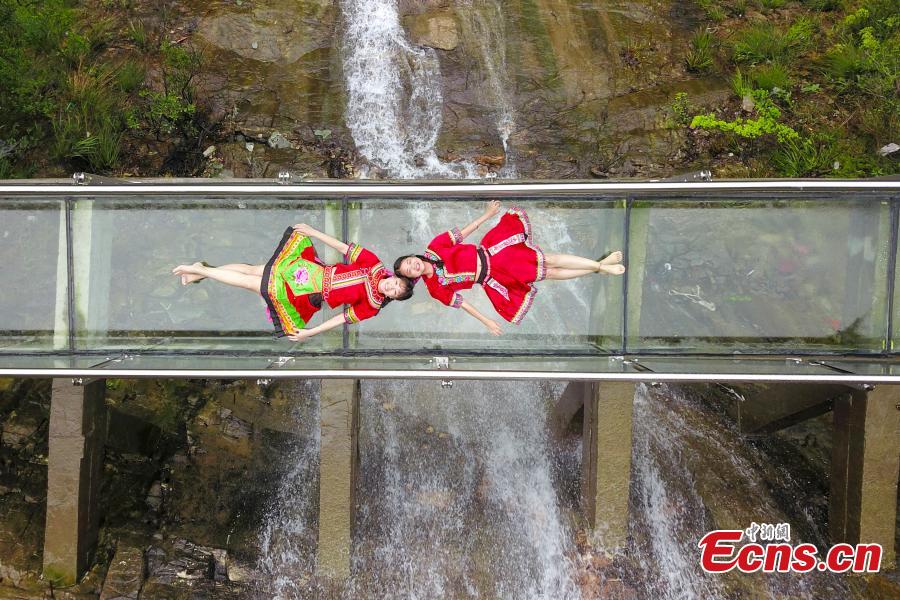 Glass walkway through waterfall opens in Hunan
